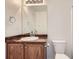 Well-lit bathroom featuring vanity and a toilet at 12993 E 108Th Ave, Commerce City, CO 80022