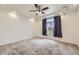 Spacious bedroom with neutral carpet, a ceiling fan, and a window with curtains at 12993 E 108Th Ave, Commerce City, CO 80022