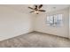 Neutral bedroom features wall-to-wall carpet, a ceiling fan, and a window at 12993 E 108Th Ave, Commerce City, CO 80022