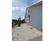Home exterior featuring gravel landscaping, light blue siding, and a fenced-in yard at 12993 E 108Th Ave, Commerce City, CO 80022
