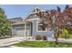 A cozy home exterior showing the garage, lawn, and well-placed landscaping at 12993 E 108Th Ave, Commerce City, CO 80022