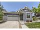 Inviting front exterior with blue siding, well-manicured lawn, and a two-car garage at 12993 E 108Th Ave, Commerce City, CO 80022