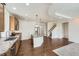 Open kitchen with stainless steel appliances, wood cabinets, stone countertops and island that opens to the living room at 12993 E 108Th Ave, Commerce City, CO 80022