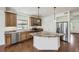 Bright kitchen features stainless steel appliances, wood cabinets, and a large island with a stone countertop at 12993 E 108Th Ave, Commerce City, CO 80022