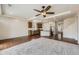 Open-concept living room with a ceiling fan, hardwood, and carpet that flows into the kitchen area at 12993 E 108Th Ave, Commerce City, CO 80022