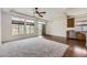 Bright living room with plush carpet, hardwood flooring, and many windows providing outdoor views at 12993 E 108Th Ave, Commerce City, CO 80022
