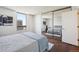 A bedroom featuring wood floors, a large window and a mirrored closet at 1020 15Th St # 28G, Denver, CO 80202