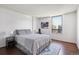 A bedroom featuring wood floors, a large window and a bed at 1020 15Th St # 28G, Denver, CO 80202