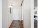 Inviting hallway with wood floors, mirrored closet, and white door at 1020 15Th St # 28G, Denver, CO 80202