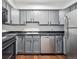 A kitchen featuring stainless steel appliances and gray cabinets at 1020 15Th St # 28G, Denver, CO 80202