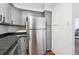 A kitchen featuring a stainless steel refrigerator and gray cabinets at 1020 15Th St # 28G, Denver, CO 80202