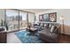 Well-decorated living room with leather sofa, city views, and natural light at 1020 15Th St # 28G, Denver, CO 80202