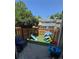 Fully fenced backyard with artificial turf and play structures, ideal for outdoor fun at 15507 E Louisiana Ave, Aurora, CO 80017