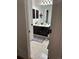 Bathroom featuring double sinks, black cabinets and drawers, and unique flooring at 15507 E Louisiana Ave, Aurora, CO 80017