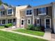 Charming townhome featuring stone accents, well-maintained landscaping, and inviting front entrances at 15507 E Louisiana Ave, Aurora, CO 80017