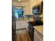 Well-equipped kitchen featuring stainless steel appliances, granite countertops and wood look floors at 15507 E Louisiana Ave, Aurora, CO 80017