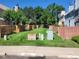 A communal grassy area is shown with utility boxes and wooden privacy fences at 15507 E Louisiana Ave, Aurora, CO 80017