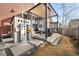 Private backyard with a pergola-covered patio, cozy seating, and a delightful playhouse, perfect for outdoor enjoyment at 1691 W 66Th Ave, Denver, CO 80221