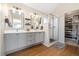 Bathroom featuring double vanity, walk-in glass shower and open-concept walk-in closet at 1691 W 66Th Ave, Denver, CO 80221