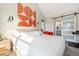 Stylish bedroom featuring modern art, natural light, and ensuite bathroom with sliding barn door at 1691 W 66Th Ave, Denver, CO 80221