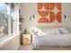 Cozy bedroom featuring modern decor, bedside shelves, and natural light from a window at 1691 W 66Th Ave, Denver, CO 80221