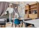 Bright dining area features stylish light fixture, modern table, and sliding glass doors at 1691 W 66Th Ave, Denver, CO 80221