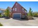 Exterior view of a home with a spacious two-car garage and modern design at 1691 W 66Th Ave, Denver, CO 80221