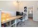 Bright home office featuring a built-in desk, stylish light fixture, and easy access to a full bathroom at 1691 W 66Th Ave, Denver, CO 80221