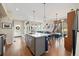 Bright open-concept kitchen with island seating flowing into the dining and living areas at 1691 W 66Th Ave, Denver, CO 80221
