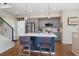Modern kitchen with stainless steel appliances, a center island, and stylish pendant lighting at 1691 W 66Th Ave, Denver, CO 80221