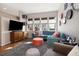 Cozy living room with large windows, stylish furniture, and a comfortable seating arrangement at 1691 W 66Th Ave, Denver, CO 80221
