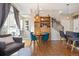 Bright open-plan living and dining area with hardwood floors and large windows at 1691 W 66Th Ave, Denver, CO 80221