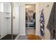 Modern walk-in closet and glass shower with a large open space for storage at 1691 W 66Th Ave, Denver, CO 80221