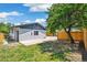 Backyard features a large tree, fence, and grassy area, providing a private outdoor space at 2767 W Iliff Ave # 1, Denver, CO 80219