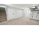 Finished basement with plush carpeting, sink, and stairway to the main level at 2767 W Iliff Ave # 1, Denver, CO 80219
