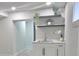 Finished basement wet bar including white cabinets and stone counter at 2767 W Iliff Ave # 1, Denver, CO 80219