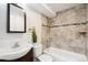 Bathroom with tub and tiled walls at 2767 W Iliff Ave # 1, Denver, CO 80219