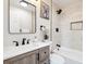 Updated bathroom with modern fixtures, subway tile shower, and wooden vanity at 2767 W Iliff Ave # 1, Denver, CO 80219