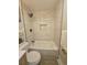 Modern bathroom with a tub and shower featuring light tile and black trim at 2767 W Iliff Ave # 1, Denver, CO 80219