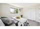 Comfortable bedroom featuring a double door closet, plush throw and black framed window at 2767 W Iliff Ave # 1, Denver, CO 80219