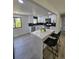 Bright kitchen boasts white cabinets, stainless appliances, and a large island with seating at 2767 W Iliff Ave # 1, Denver, CO 80219