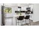 Modern kitchen featuring white cabinets, stainless steel appliances, and center island with bar seating at 2767 W Iliff Ave # 1, Denver, CO 80219