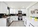 Modern kitchen with black backsplash, stainless steel appliances and a large island, great for entertaining at 2767 W Iliff Ave # 1, Denver, CO 80219