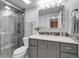 Modern bathroom featuring sleek gray vanity, elegant tiling, and glass-enclosed shower at 7318 S Xenia Cir # B, Centennial, CO 80112