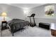 Spacious bedroom with natural light, neutral decor, and space for a treadmill at 7318 S Xenia Cir # B, Centennial, CO 80112
