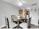 Bright dining area with a round table, stylish chairs, and view of the kitchen and laundry area at 7318 S Xenia Cir # B, Centennial, CO 80112