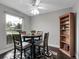 Cozy dining area with stylish table set, bookshelf, and a large window at 7318 S Xenia Cir # B, Centennial, CO 80112
