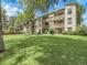 Well-maintained condominium building with lush green spaces and mature trees at 7318 S Xenia Cir # B, Centennial, CO 80112