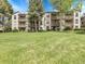 Well-maintained condo building with balconies surrounded by a lush green lawn at 7318 S Xenia Cir # B, Centennial, CO 80112