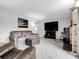 Bright living room with soft carpet, a large TV, and modern furnishings at 7318 S Xenia Cir # B, Centennial, CO 80112